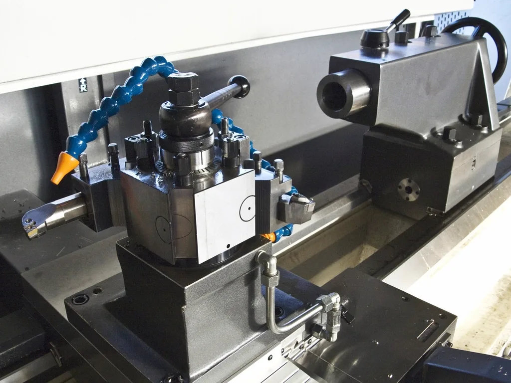 A CNC lathe with coolant lines, set up mid job